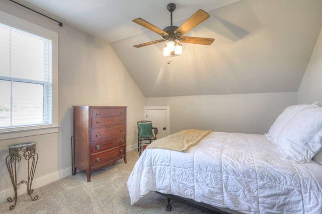 bedroom with ceiling fan, light colored carpet, and lofted ceiling