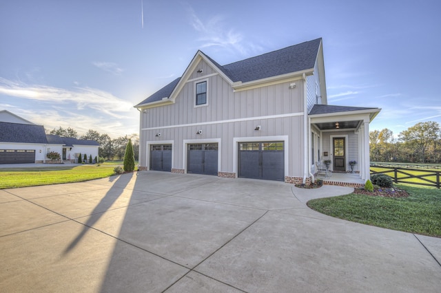 view of side of property with a yard and a garage