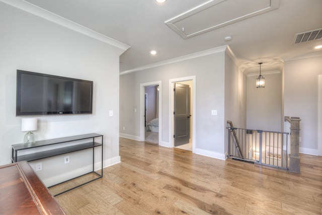 living room with light hardwood / wood-style floors and crown molding