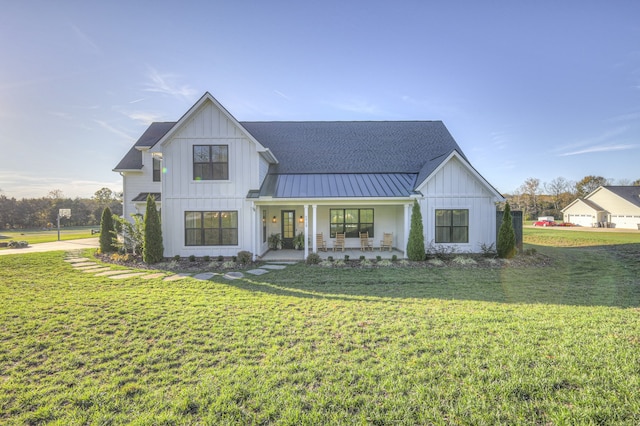 view of front of house featuring covered porch and a front lawn