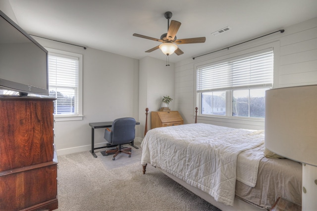 bedroom featuring light colored carpet and ceiling fan