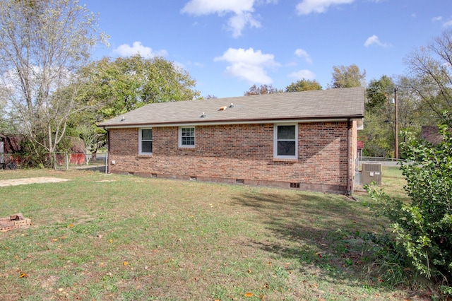 back of property with a lawn