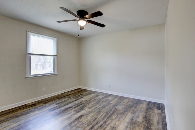 unfurnished room with ceiling fan, dark hardwood / wood-style flooring, and a textured ceiling