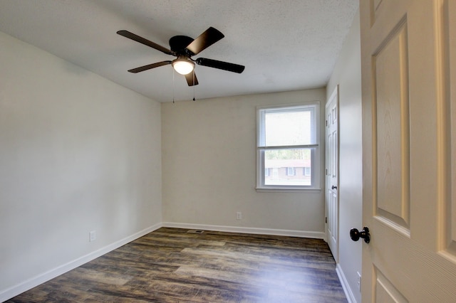 spare room with ceiling fan, dark hardwood / wood-style flooring, and a textured ceiling