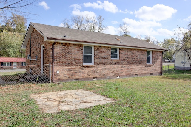 view of property exterior featuring a lawn and a patio