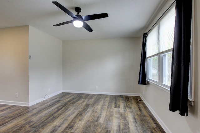 empty room featuring dark hardwood / wood-style flooring and ceiling fan