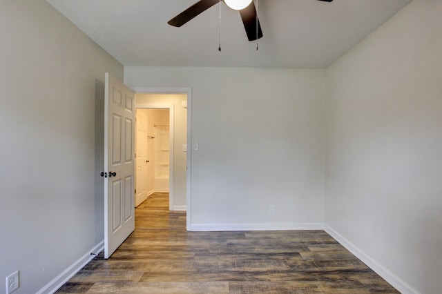 unfurnished room with ceiling fan and dark hardwood / wood-style floors