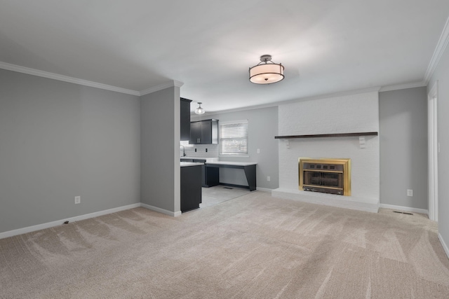 unfurnished living room with a fireplace, light colored carpet, and crown molding