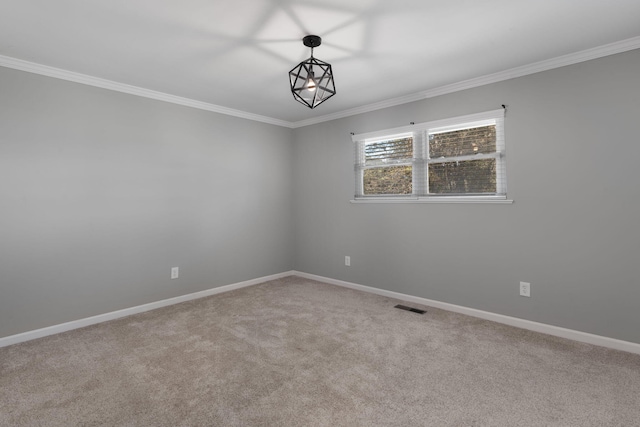 carpeted spare room featuring crown molding