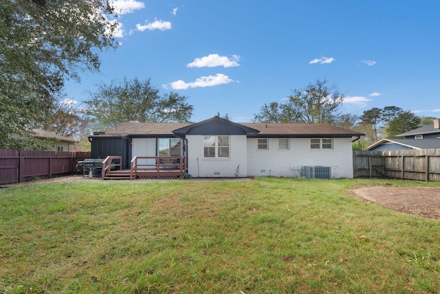 back of property with a yard, central AC, and a wooden deck