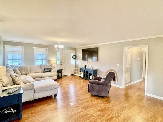 living room featuring hardwood / wood-style flooring, crown molding, and a notable chandelier