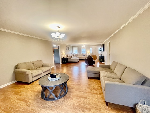 living room featuring a chandelier, ornamental molding, and light hardwood / wood-style flooring