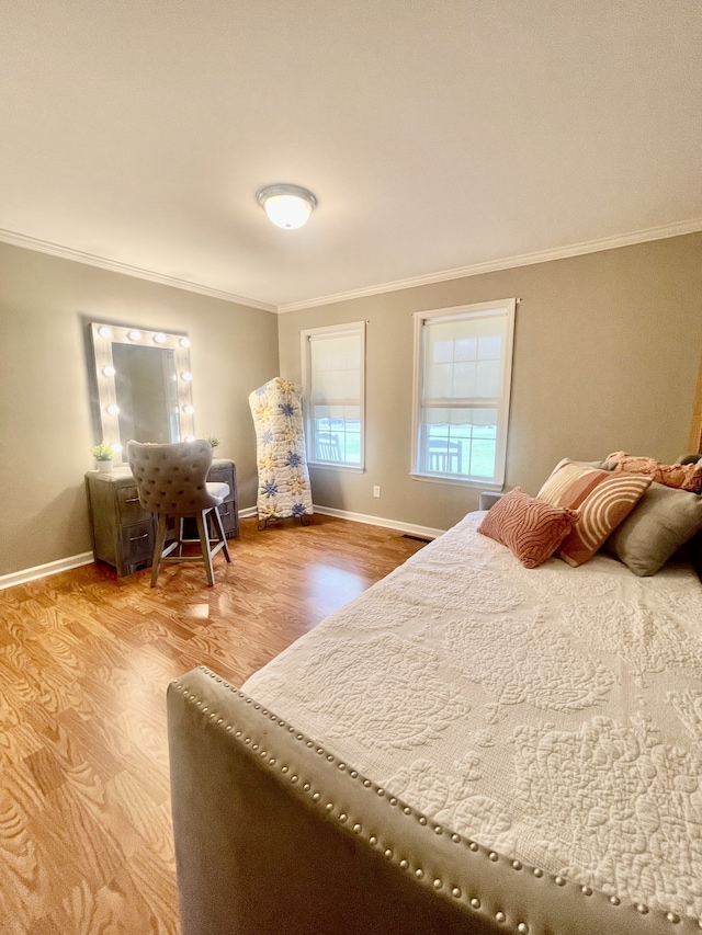 bedroom with crown molding and wood-type flooring