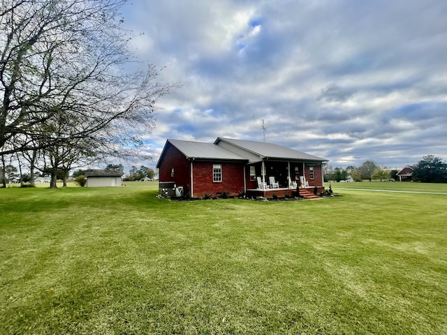 exterior space with covered porch and a lawn