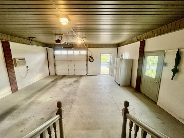 garage with a wall mounted AC, a garage door opener, and white fridge with ice dispenser