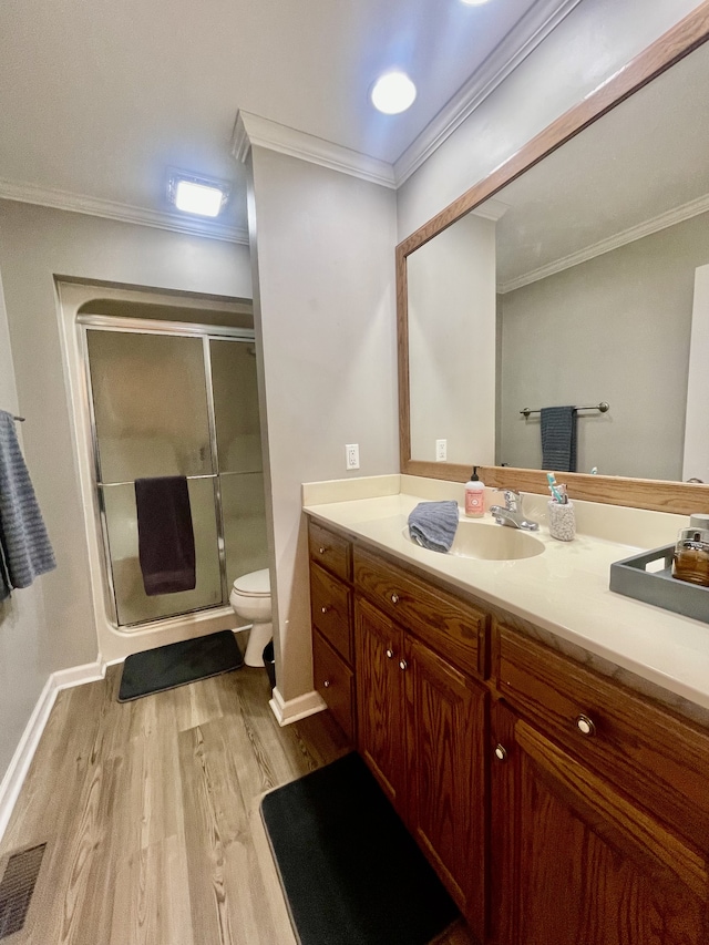 bathroom featuring hardwood / wood-style floors, vanity, toilet, and crown molding