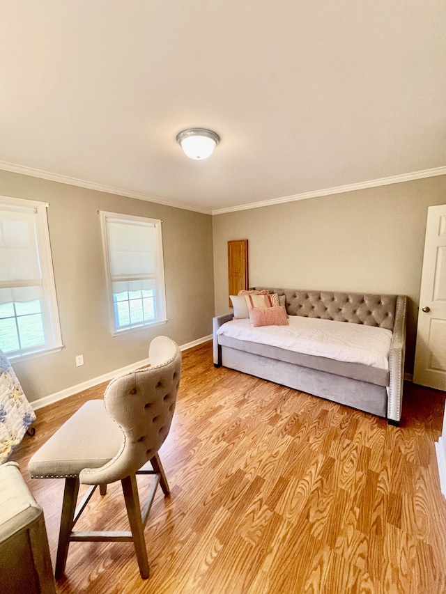 bedroom with light wood-type flooring and crown molding