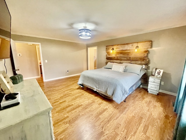 bedroom featuring light wood-type flooring, ceiling fan, and ornamental molding