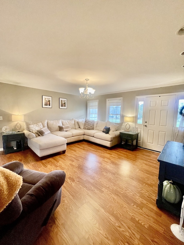 living room featuring light wood-type flooring and an inviting chandelier