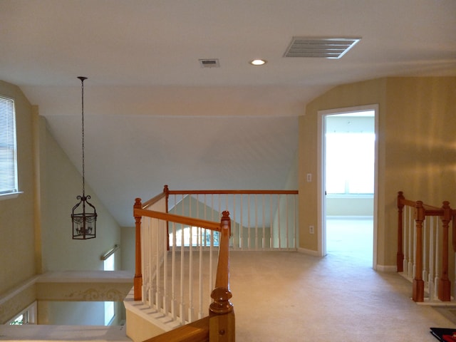 stairway with carpet floors and vaulted ceiling