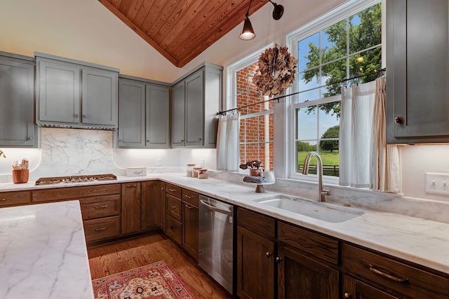 kitchen with sink, stainless steel appliances, vaulted ceiling, wood ceiling, and light wood-type flooring