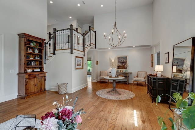 dining room with wood-type flooring, a high ceiling, and a chandelier