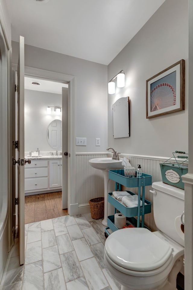 bathroom with hardwood / wood-style floors and toilet