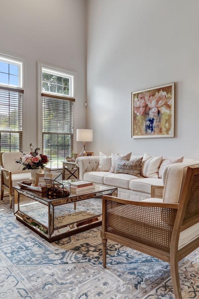 living room with a towering ceiling and a healthy amount of sunlight