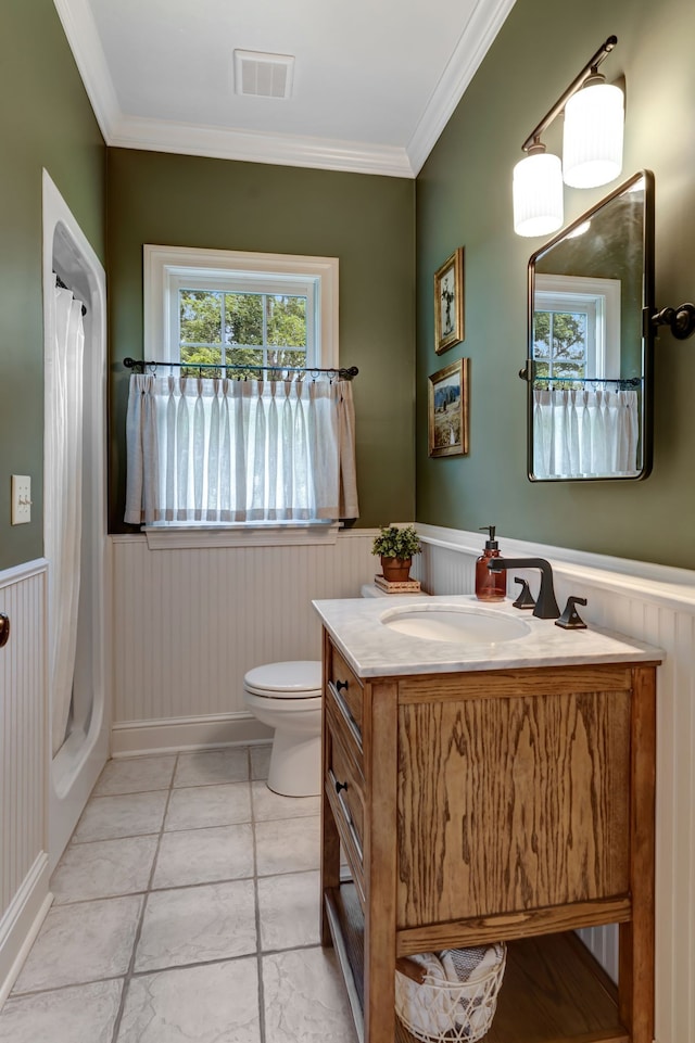 bathroom featuring toilet, vanity, a shower with shower curtain, and ornamental molding