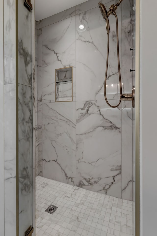 bathroom with a tile shower