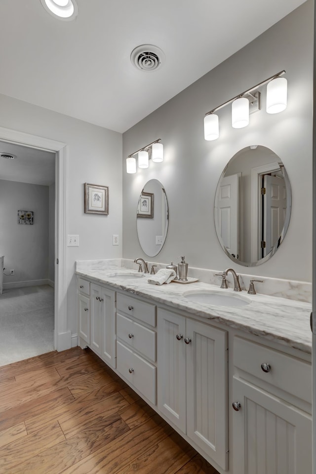 bathroom featuring vanity and hardwood / wood-style flooring