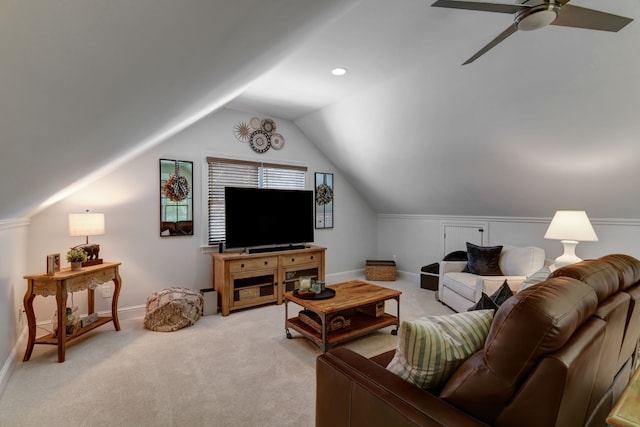 carpeted living room with ceiling fan and lofted ceiling