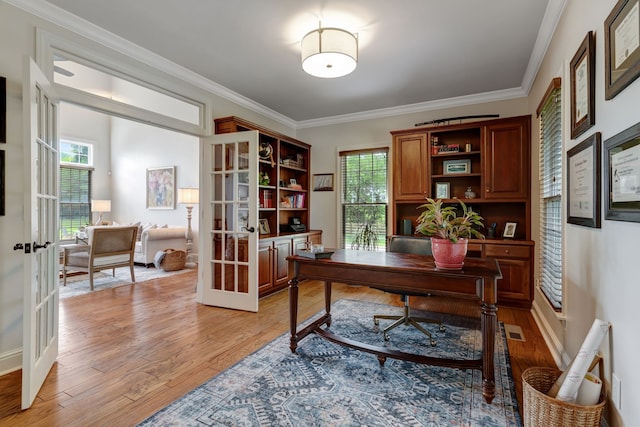 home office featuring french doors, a healthy amount of sunlight, and light wood-type flooring