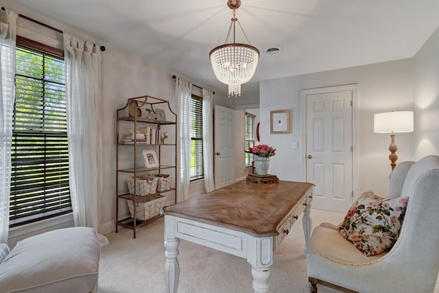 office area with a chandelier and light colored carpet