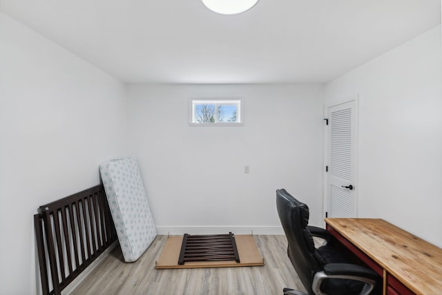 home office with light hardwood / wood-style floors