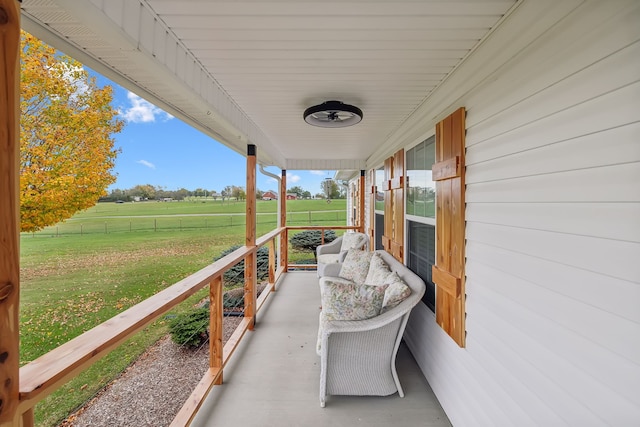 view of patio / terrace featuring a rural view and a porch