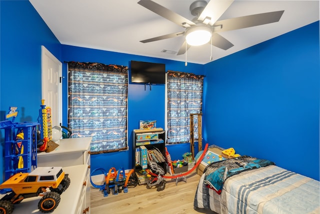 bedroom with ceiling fan and light wood-type flooring