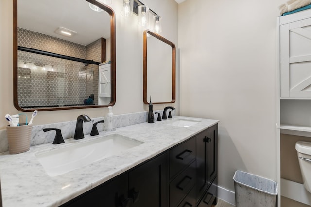 bathroom featuring an enclosed shower, vanity, and toilet