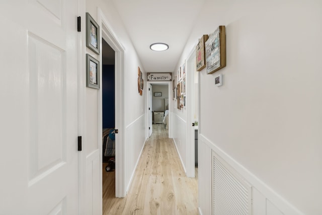 corridor with light hardwood / wood-style floors