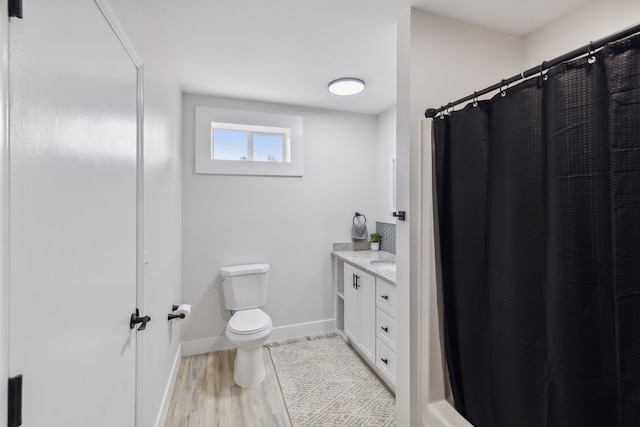 bathroom featuring hardwood / wood-style floors, vanity, and toilet