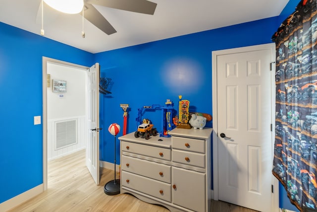 bedroom with ceiling fan and light wood-type flooring