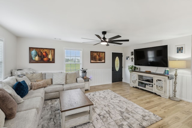 living room featuring light hardwood / wood-style floors and ceiling fan