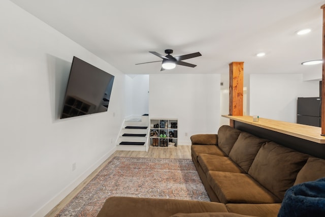 living room featuring ceiling fan and light wood-type flooring