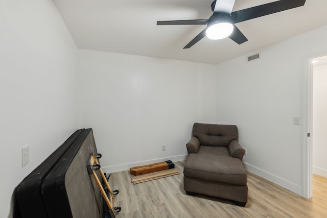 living area featuring ceiling fan and light wood-type flooring