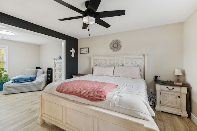 bedroom with ceiling fan and light hardwood / wood-style flooring