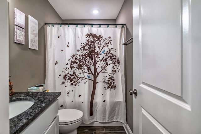 bathroom featuring tile patterned floors, vanity, and toilet