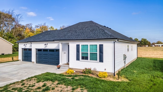 view of front of house featuring a garage and a front yard