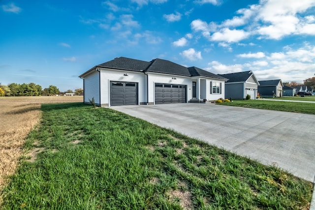 ranch-style house featuring a front yard and a garage