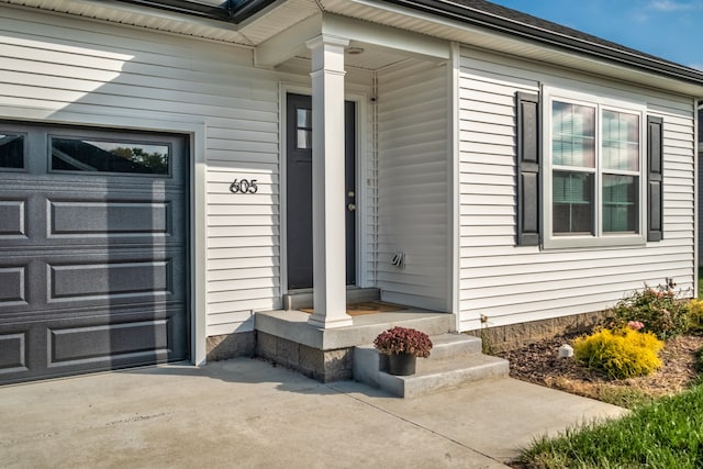 doorway to property with a garage