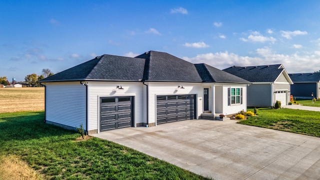 view of front of property featuring a front lawn and a garage